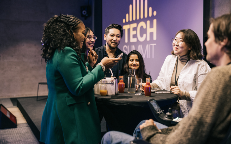 A group of tech experts socialising at a tech event